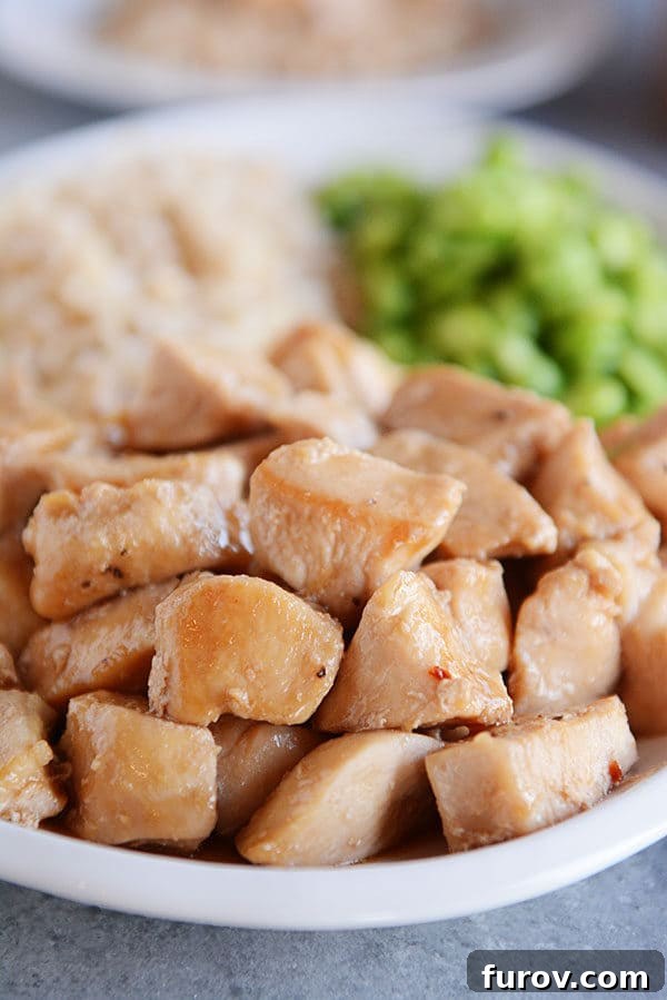 Sticky Honey Garlic Skillet Chicken in 20 Minutes 4 Glazed golden brown chicken cubes on a white plate.