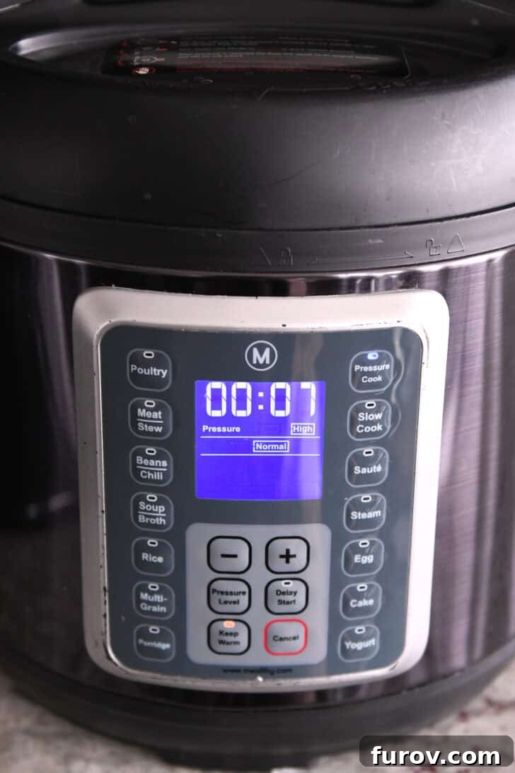 Easy Chicken Tortilla Soup Instant Pot Stovetop Slow Cooker 5 The front of an InstantPot with 7 minutes showing on the screen.
