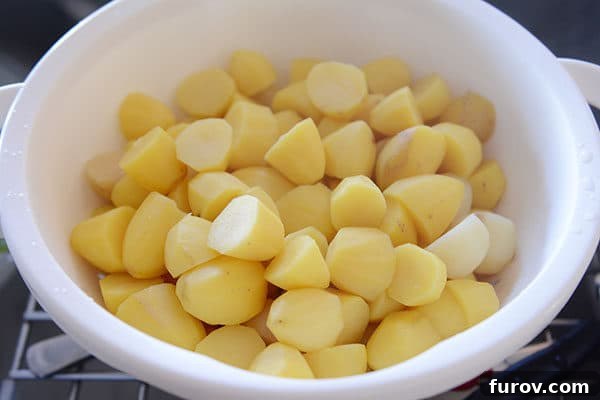 Large bowl of cooked mashed potatoes ready to be mashed. 