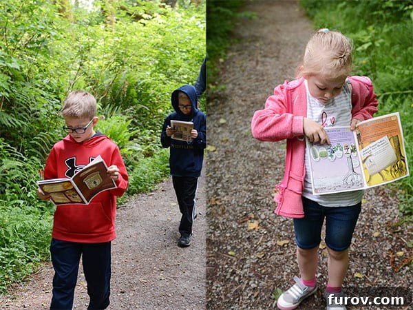 Effortless Wonders: Your Relaxed Guide to the Redwood Giants 8 Two children intensely examine their Redwood National Park Junior Ranger booklets, eager to earn their badges.