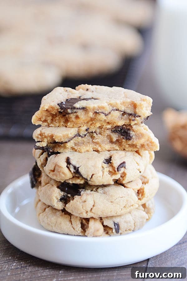 Velvety Soft Egg Free Peanut Butter Chocolate Chip Cookies 3 A stack of chocolate chip peanut butter cookies with the top cookie split in half in a white ramekin.