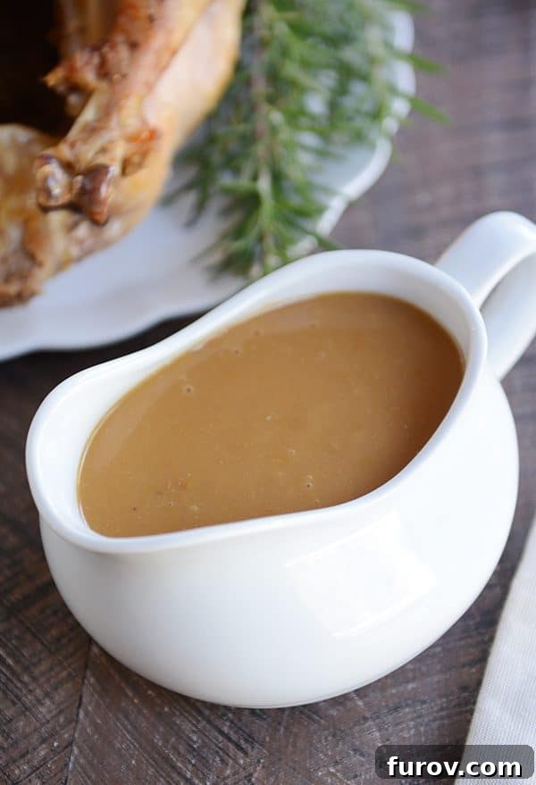 Juicy & Golden Thanksgiving Turkey in an Oven Roasting Bag 5 A large white gravy boat overflowing with rich, homemade brown gravy.