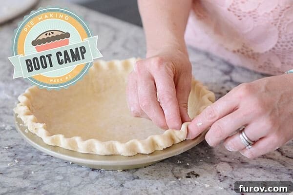 A raw pie crust getting the edges crimped. 
