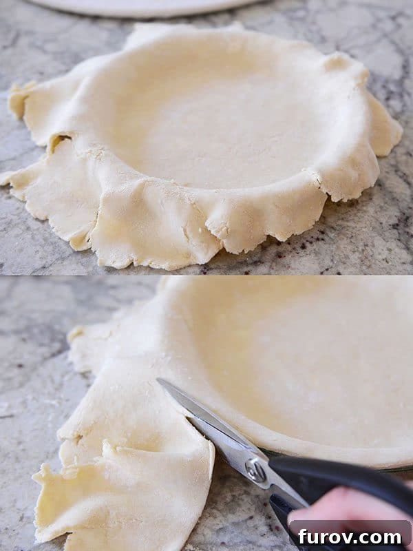 Unbaked pie crust being meticulously trimmed flush with the edge of the pie dish using kitchen shears.