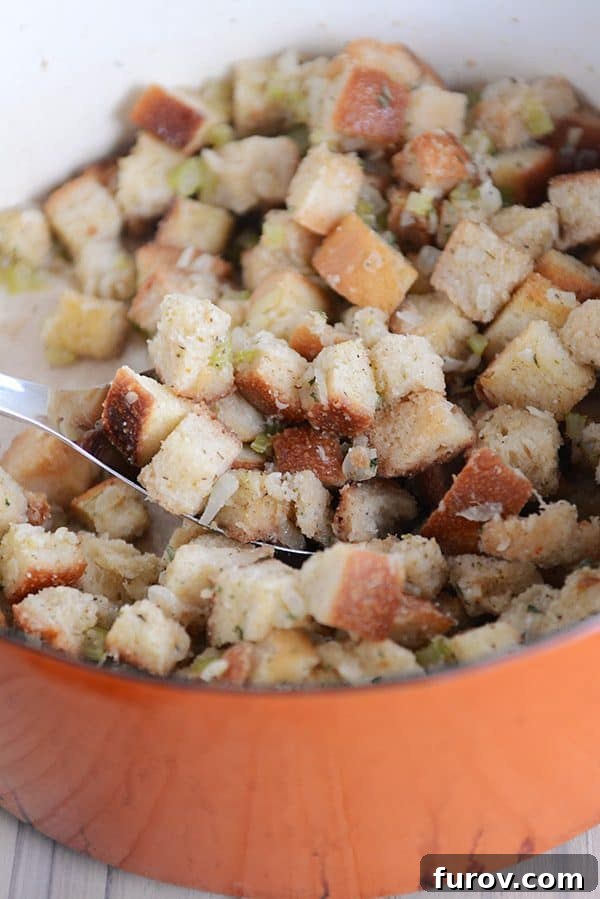 An orange pot full of homemade stuffing, ready to be served.