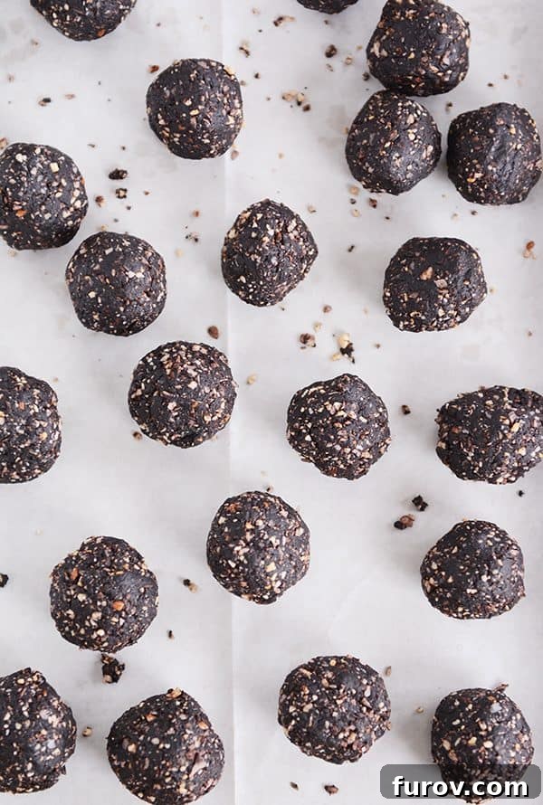 Dark chocolate almond joy bites on a sheet of parchment.