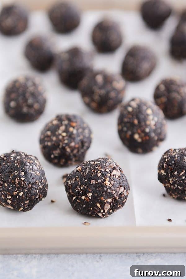 Healthy Dark Chocolate Almond Joy Bites on a piece of parchment. 