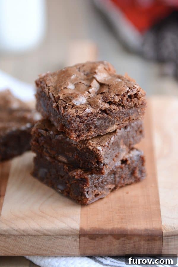 Three chocolate brownies stacked on top of each other.