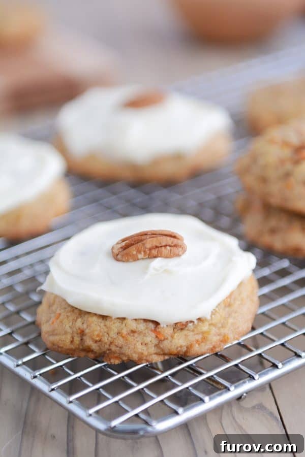 Heavenly Carrot Cake Cookies with Tangy Cream Cheese Frosting 3 A frosted carrot cake cookie cooling on a wire rack.