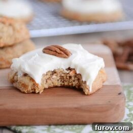 Heavenly Carrot Cake Cookies with Tangy Cream Cheese Frosting 6 Frosted carrot cake cookie with a bite taken out.