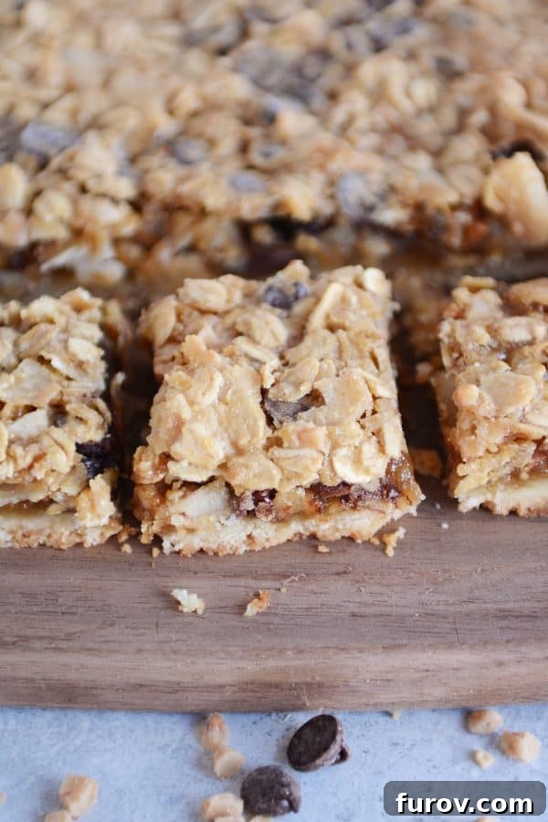 A full tray of freshly baked Caramel Oat Chocolate Chunk Shortbread Bars, ready to be cut into individual servings.