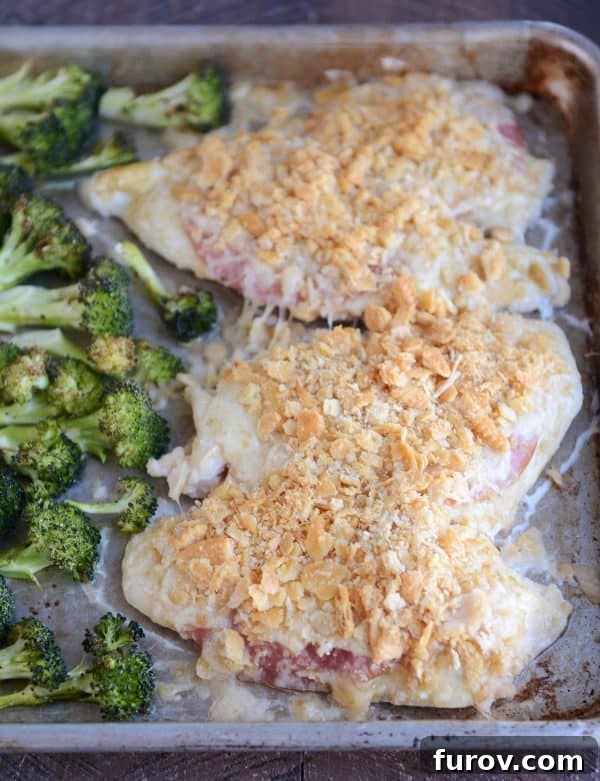 One-Pan Cordon Bleu Chicken & Broccoli Roast 3 Close-up of unstuffed sheet pan chicken cordon bleu featuring melted cheese, savory ham, and a crunchy Ritz cracker topping.