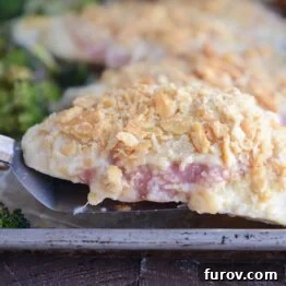 One-Pan Cordon Bleu Chicken & Broccoli Roast 6 Lifting unstuffed chicken cordon bleu with spatula, ready to serve.