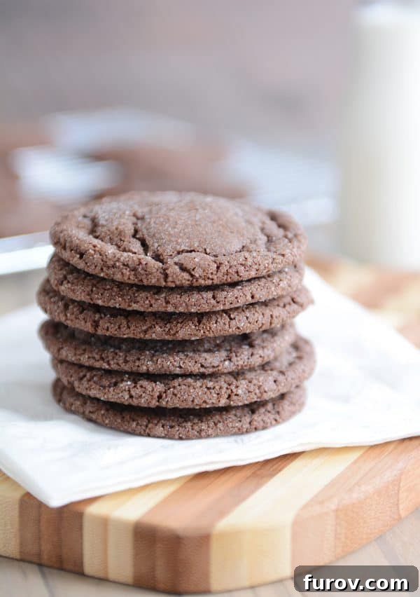 A beautiful stack of soft chocolate sugar cookies elegantly presented on a white napkin.