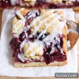 Cherry pie cookie bar on white napkin.