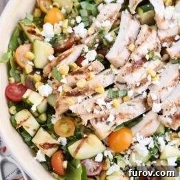 Detailed view of the grilled chicken orzo salad, highlighting the orzo pasta, chicken, and fresh vegetables.