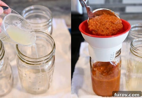 Filling quart size canning jars with homemade canned spaghetti sauce recipe.