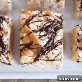 Toasted Coconut Caramel Crunch Bars 7 Top down view of Toasted Coconut Caramel Rice Krispie Treats on parchment paper.