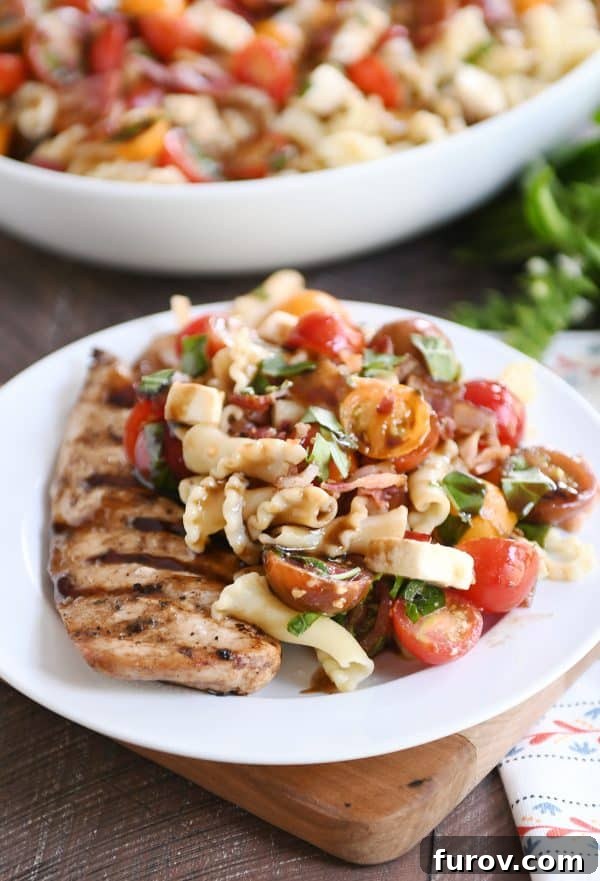 Ultimate Bruschetta Chicken Bacon Pasta 2 Bruschetta chicken and bacon pasta on white plate and bamboo board.