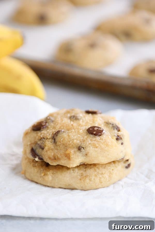 Pillowy Banana Bread Cookies 2 Stack of soft banana bread cookies on white napkin, showcasing their delightful texture and golden-brown edges. Perfect for a sweet treat or breakfast.