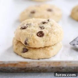 A stack of soft banana bread cookies on a white napkin, highlighting their golden texture.