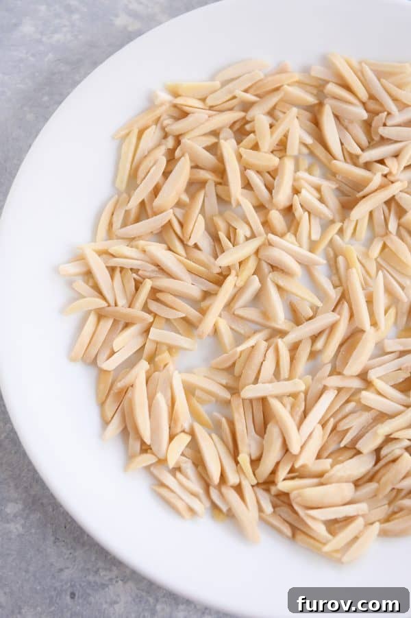 Get Perfectly Toasted Nuts in Your Microwave 3 How to toast nuts in the microwave; untoasted nuts on white plate.