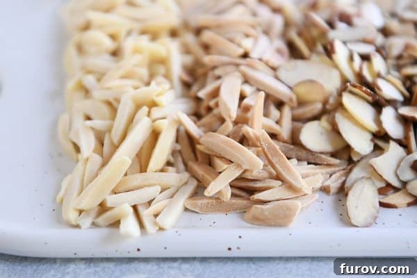 Get Perfectly Toasted Nuts in Your Microwave 6 A white plate of toasted and untoasted almonds.