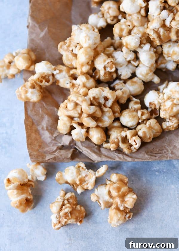 Irresistibly Soft Chewy Caramel Popcorn 2 Soft and chewy caramel popcorn on brown paper bag. A delightful, close-up shot of golden caramel popcorn.