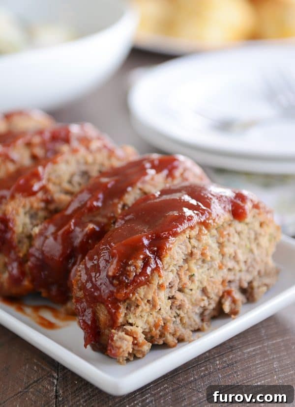 Slices of the best glazed meatloaf on white platter.
