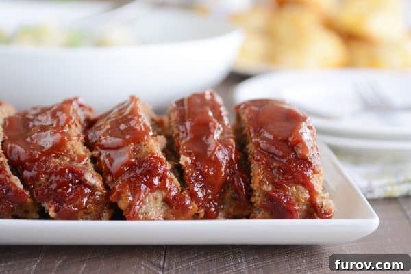 Slices of the best glazed meatloaf on white platter.