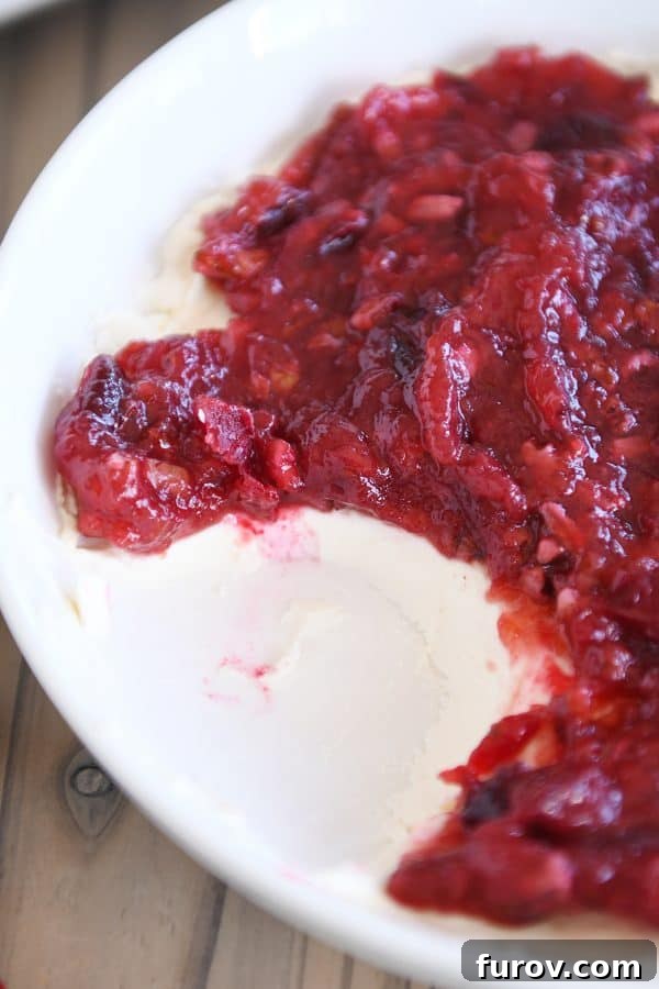 Versatile Cranberry Pecan Cream Cheese Dip 4 Close-up shot of the cranberry pecan cream cheese dip, highlighting its vibrant colors and inviting texture in a white serving bowl.