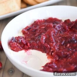 Versatile Cranberry Pecan Cream Cheese Dip 5 Cranberry pecan cream cheese dip in white bowl.