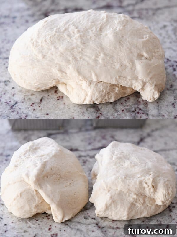 A large batch of bagel bread dough divided into two equal pieces on a granite countertop, perfectly portioned and ready for individual shaping.