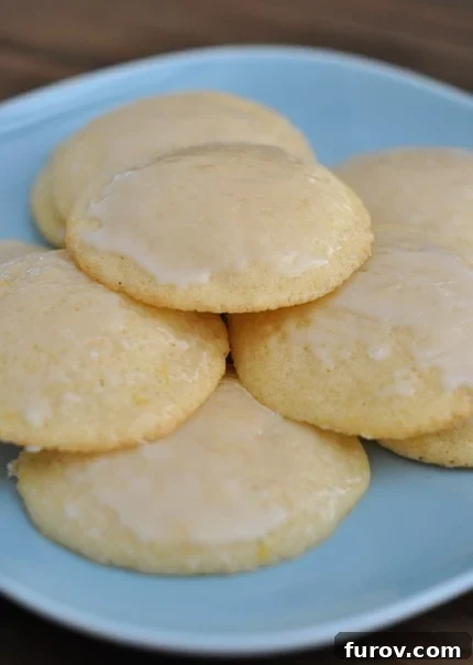 A blue plate full of glazed lemon buttermilk cookies, showcasing their inviting appearance.