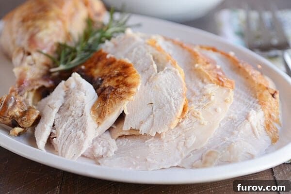 Perfectly roasted turkey with herbs, golden brown and garnished with fresh rosemary and thyme, ready for a Thanksgiving feast.