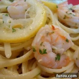 A close-up of prepared linguine with shrimp scampi, ready to be served, showcasing the rich sauce and tender shrimp.