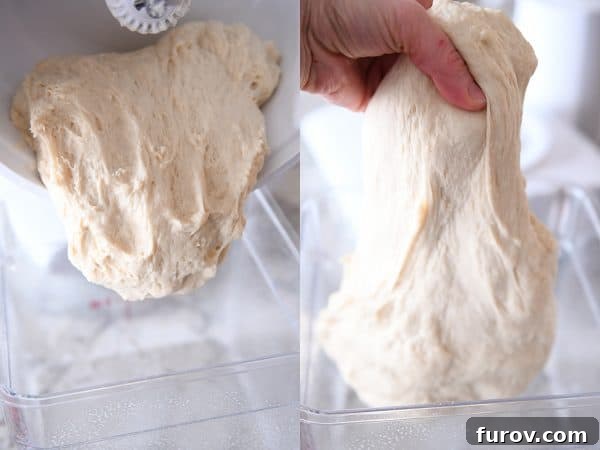 Master Cheryl's Famous Cinnamon Rolls: A Step-by-Step Guide to the Best Recipe and Baking Secrets 18 A hand gently stretching a portion of the soft and elastic cinnamon roll dough, demonstrating its ideal texture.
