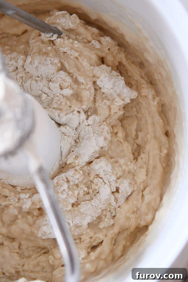 Master Cheryl's Famous Cinnamon Rolls: A Step-by-Step Guide to the Best Recipe and Baking Secrets 10 The initial sponge mixture being gently mixed in a stand mixer, showing its wet and loose consistency before further ingredients are added.