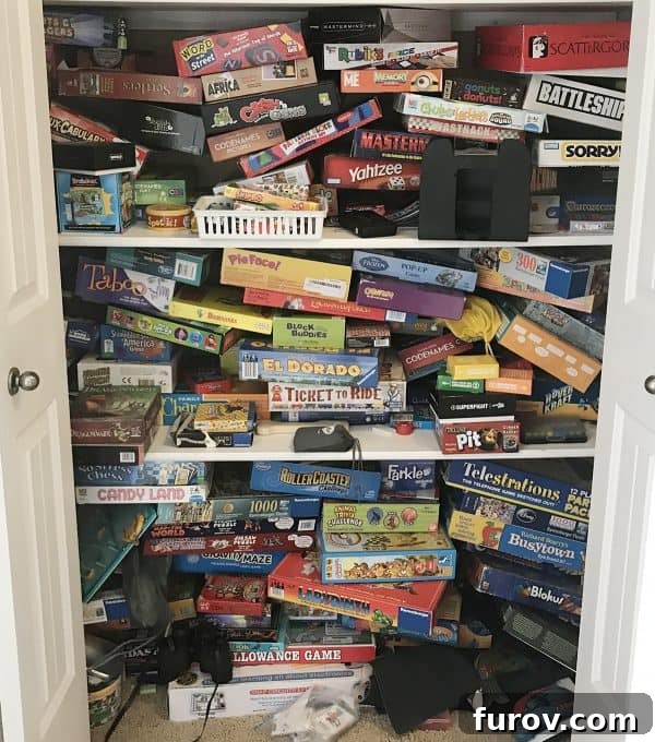 Disorganized shelf full of board games and card games, symbolizing a family's game collection