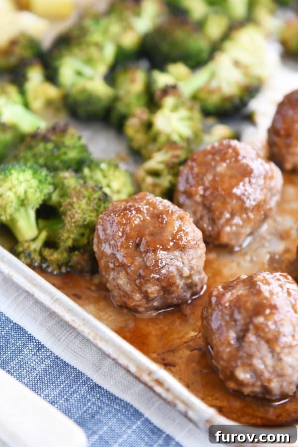 One-Pan Sweet & Sour Meatballs, Roasted Potatoes & Broccoli 3 Cooked sweet and sour sheet pan meatballs, golden roasted potatoes, and bright green broccoli florets neatly arranged on a baking sheet, fresh out of the oven.