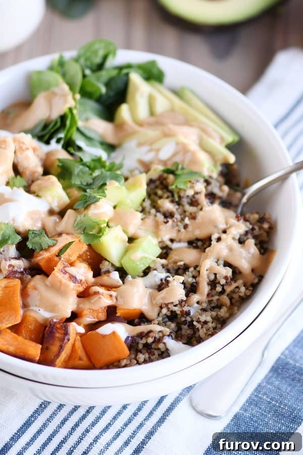 Mel's Buddha Bowls with Signature Peanut Sauce 3 Assembled Buddha bowl recipe with peanut sauce in white bowl with fork.