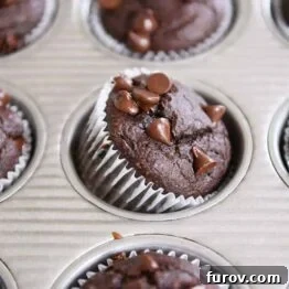 Double Chocolate Banana Blender Muffin propped on side in metal tin.