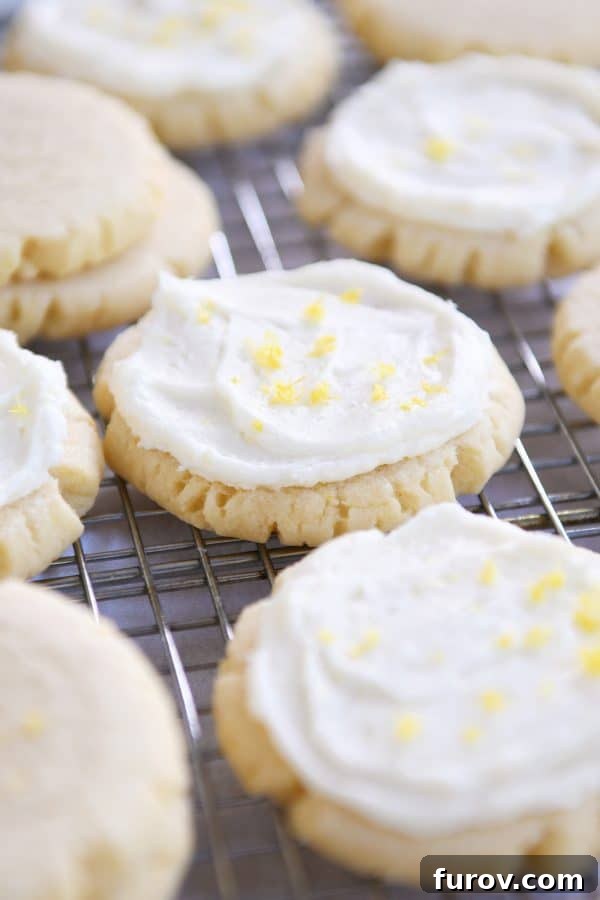 Easy Swig Lemon Sugar Cookies with Bright Lemon Frosting 2 Frosted lemon swig sugar cookies on wire cooling rack.
