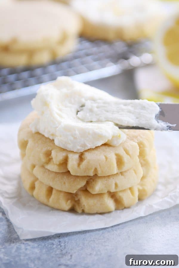 Easy Swig Lemon Sugar Cookies with Bright Lemon Frosting 3 Stack of three lemon swig sugar cookies with pile of frosting on top.