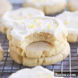 Bite taken out of frosted lemon swig sugar cookies.