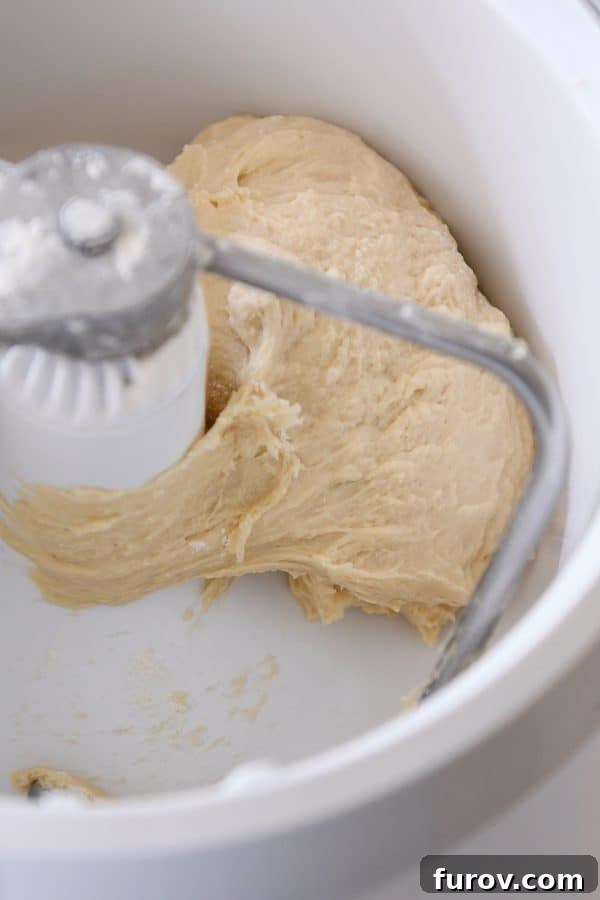 Buttery pull apart bundt bread dough being expertly mixed in a Bosch stand mixer, demonstrating the smooth texture being achieved.