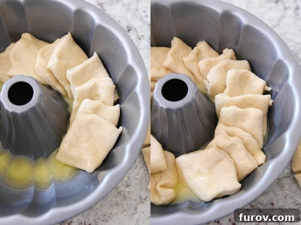 An overhead shot showing squares of dough being carefully layered in a bundt pan, forming the base for the pull-apart bread.