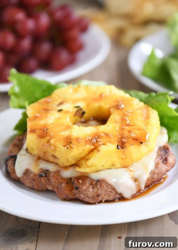 Teriyaki turkey burgers without a bun, topped with grilled pineapple and melted Swiss cheese.