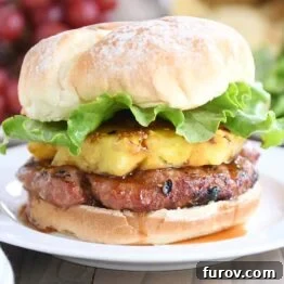 Teriyaki turkey burgers with grilled pineapple, lettuce, and soft bun.