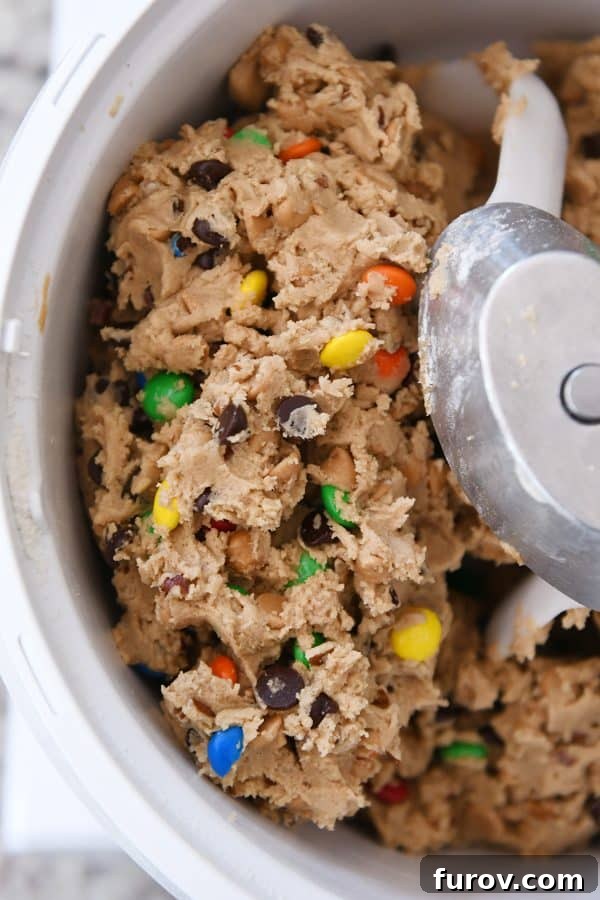 Sweet and Salty Peanut Butter Kitchen Sink Cookies 6 Rich peanut butter cookie dough, generously studded with various mix-ins, being blended in a Bosch stand mixer.